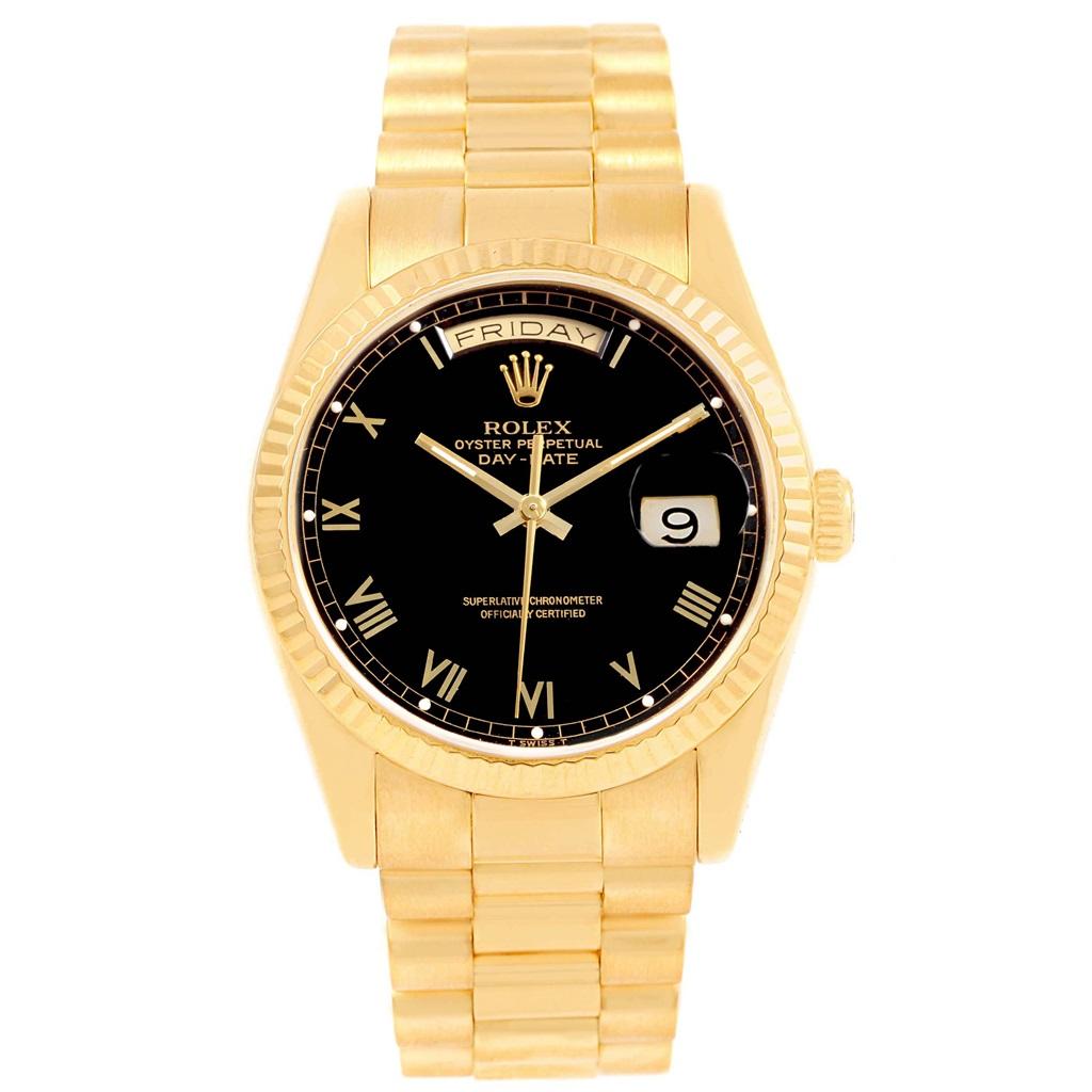 Rolex President Day-Date Yellow Gold Black Roman Dial Mens Watch 18238. Officially certified chronometer automatic self-winding movement. 18k yellow gold oyster case 36 mm in diameter. Rolex logo on a crown. 18k yellow gold fluted bezel. Scratch