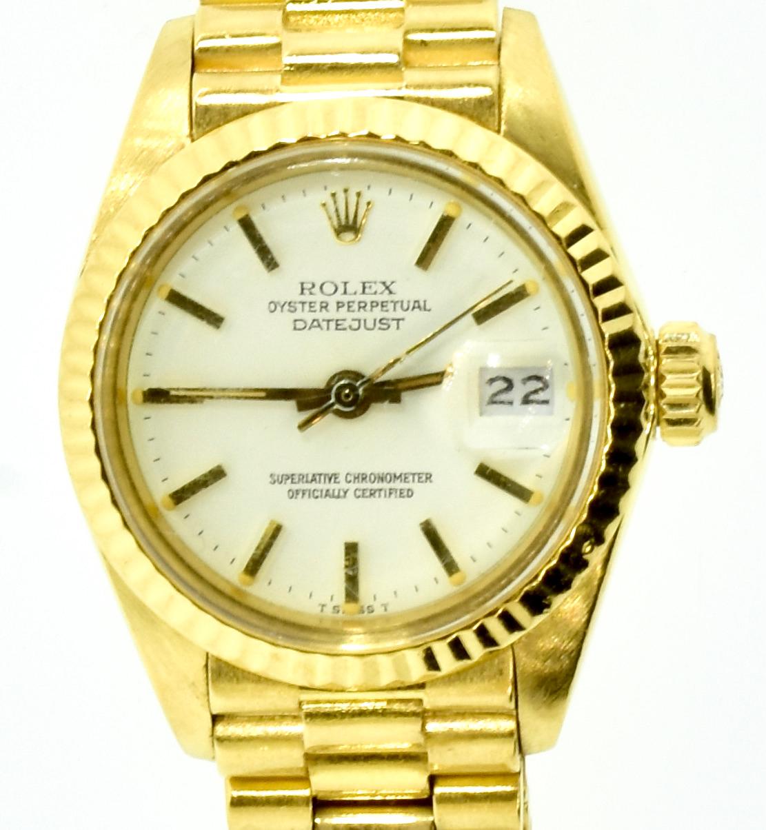 Ladies President Rolex, 26 mm., with original certificate from Rolex and the original purchase receipt with two original Rolex dials - one white and one blue.  Also accompanied the wristwatch are original set of Rolex hands. 
Model R691780
Pressure