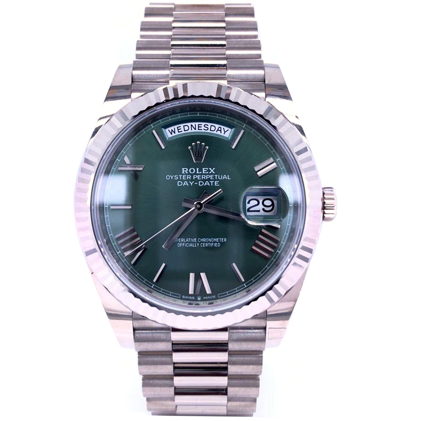The Oyster Perpetual Day-Date 40 in 18 ct white gold with an olive green dial, fluted bezel, and a President bracelet. The Day-Date was the first watch to indicate the day of the week spelled out in full when it was first presented in 1956. The