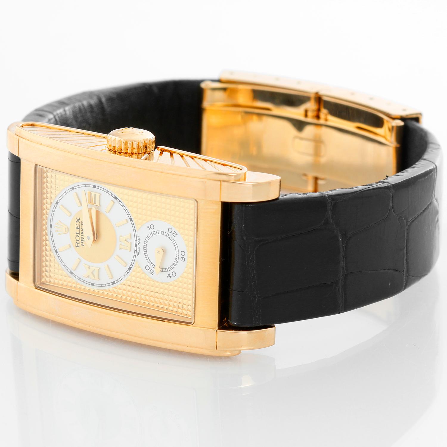Rolex Prince Cellini Men's 18k Yellow Gold Watch 5440/8 - Manual winding. 18k yellow gold case with exposition back. Gold textured dial and round ivory colored hour/minutes dial with Roman numeral markers and seconds subdial below. Black strap band