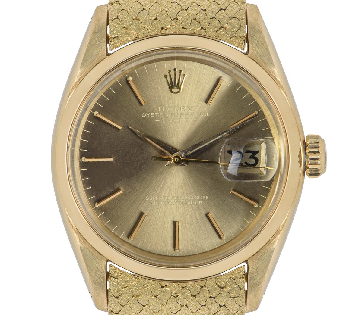 A rare vintage Date by Rolex, in yellow gold. Featuring a champagne dial with a smooth finish bezel. Equipped with a yellow gold bracelet and a rare hammered finish which is bound by a deployment clasp that has a raised monogram.

Fitted with a
