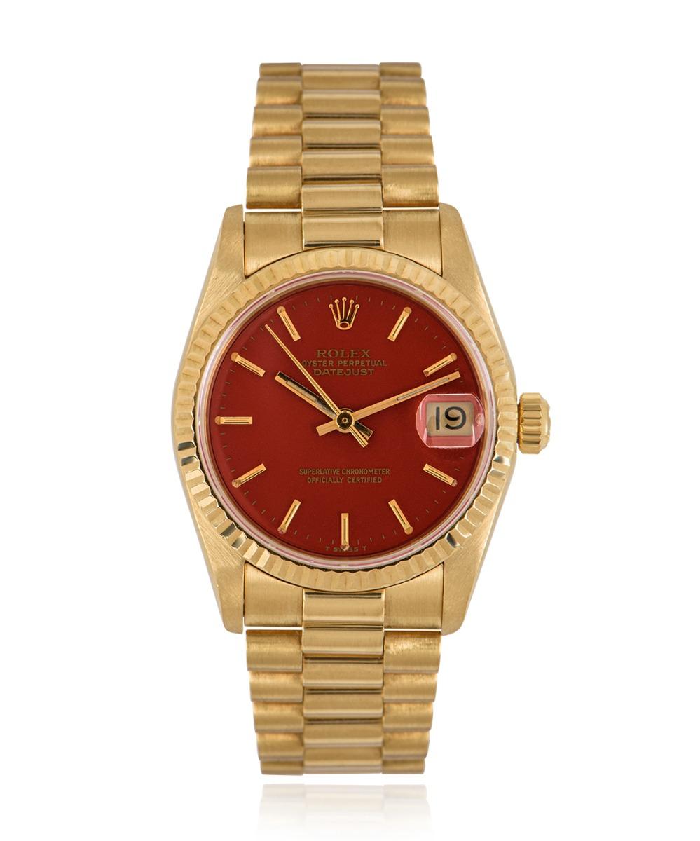 A vintage yellow gold 31mm Datejust wristwatch. Featuring a rare coral stella dial with applied hour markers and a fixed 18k yellow gold fluted bezel. The yellow gold president bracelet comes equipped with a concealed deployant clasp. Fitted with a