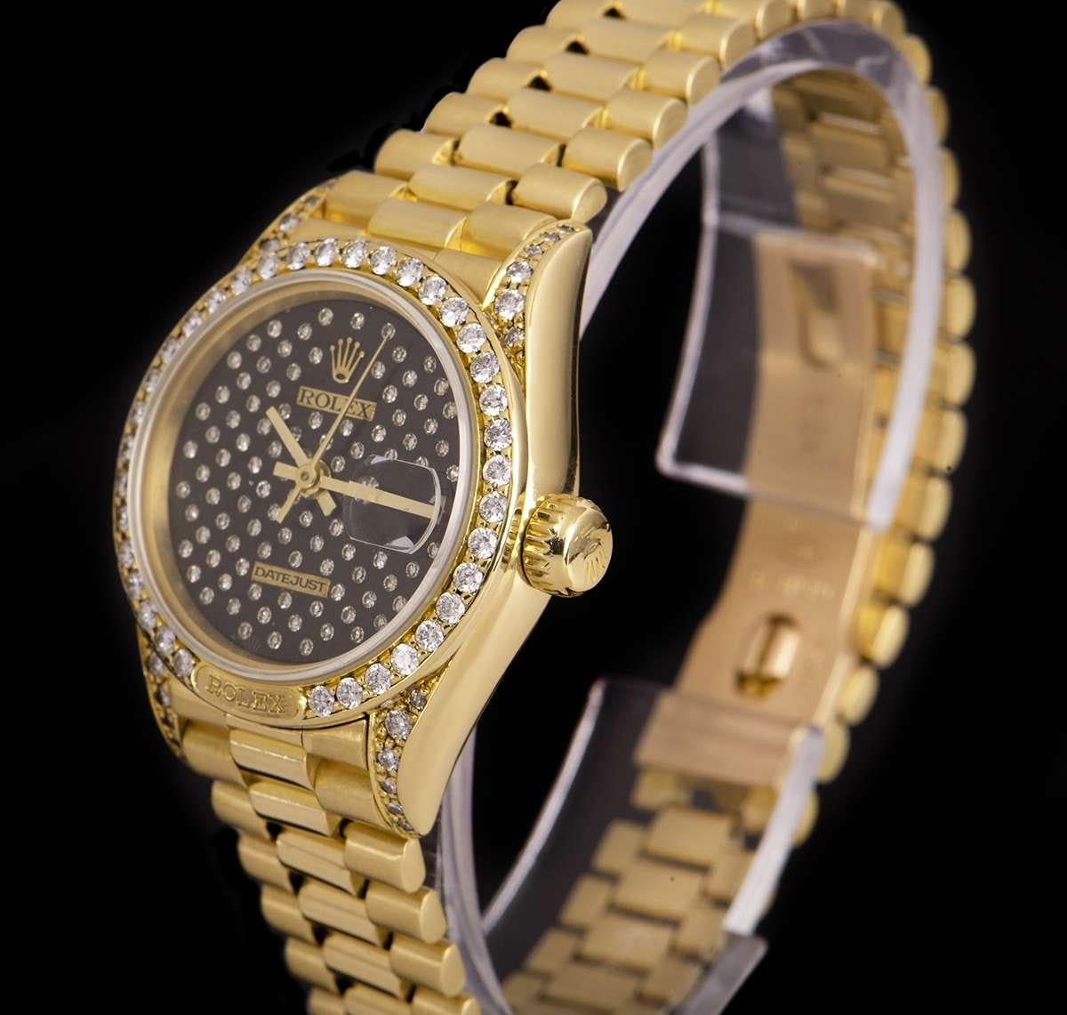 An 18k Yellow Gold Oyster Perpetual Datejust Ladies Wristwatch, rare pleiade diamond black dial set with approximately 98 applied round brilliant diamonds, date at 3 0'clock, a fixed 18k yellow gold bezel set with approximately 36 round brilliant