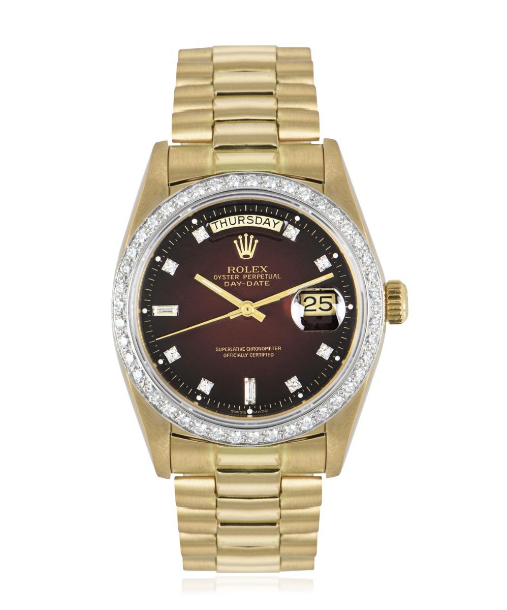 A stunning 36mm Day-Date crafted in 18k yellow gold by Rolex. Featuring a uniquely rare maroon vignette dial set with 8 single cut diamonds and 2 baguette diamond hour markers. Complementing the dial is a yellow gold fixed bezel set with 43 round