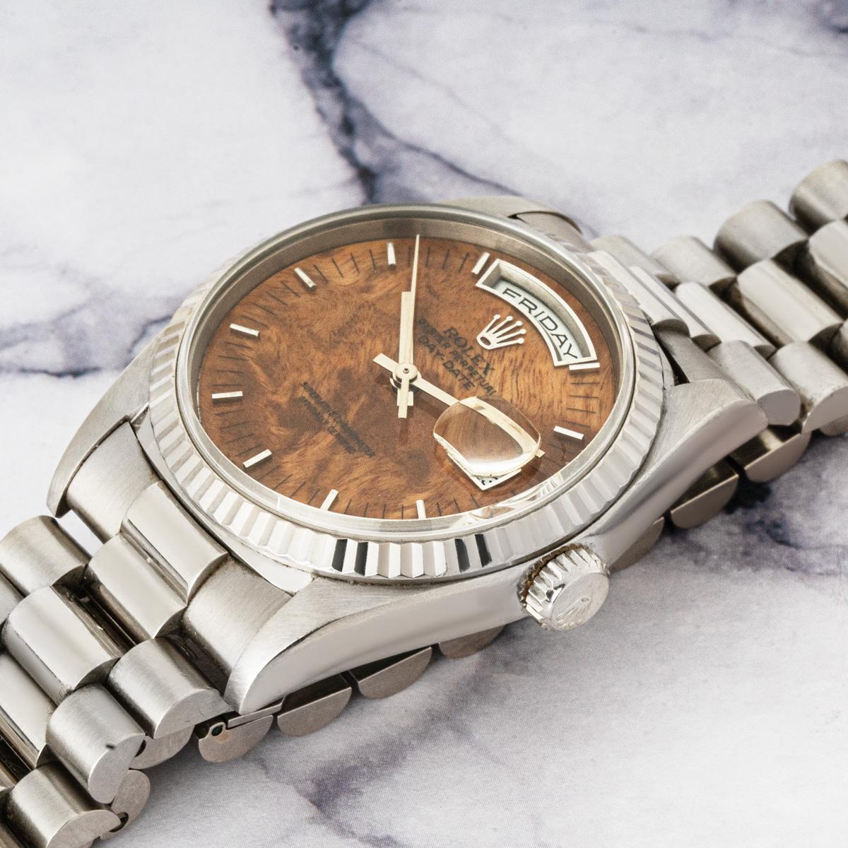 A 36mm Day-Date by Rolex. Produced in white gold and featuring a wood dial, this combination is extremely rare to find in the market. The fluted bezel, president bracelet, and concealed clasp are traditional characteristics of a Day-Date.

Fitted
