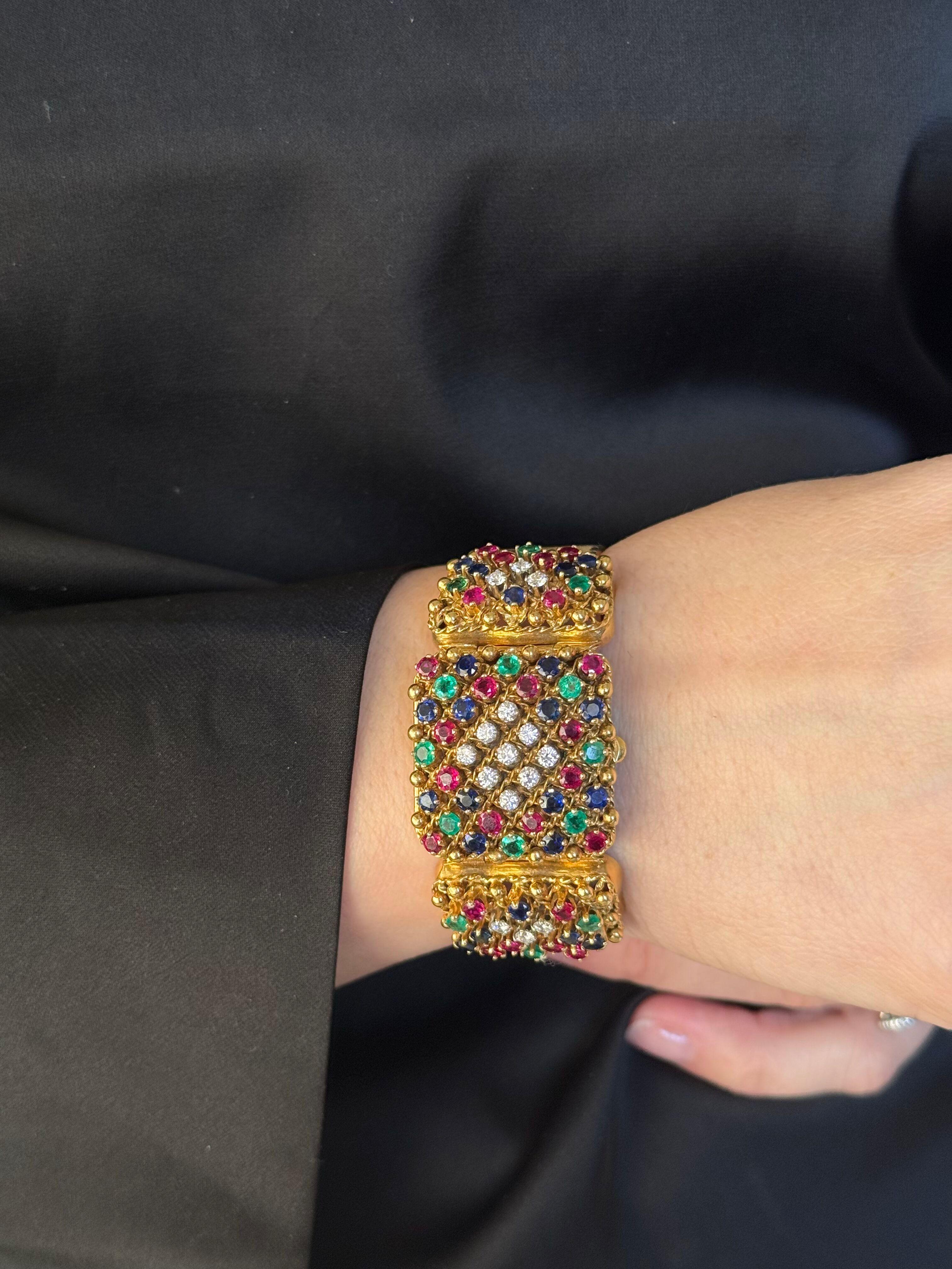 Rare Midcentury circa 1950s Retro style 18k gold watch bracelet, decorated with rubies, sapphires, emeralds and approx. 0.75ctw G/VS diamonds. Case measures 28mm x 28mm. Bracelet is 6 5/8