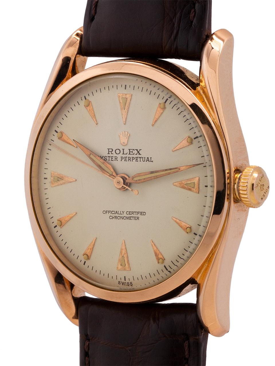 Rare example Rolex 18K rose gold Bombe ref # 6090 serial# xxx,xxx circa 1951. Featuring 33 x 40mm bombe style case with bowed lugs, smooth bezel, acrylic crystal, and very pleasing professionally restored antique white dial with rose gold applied