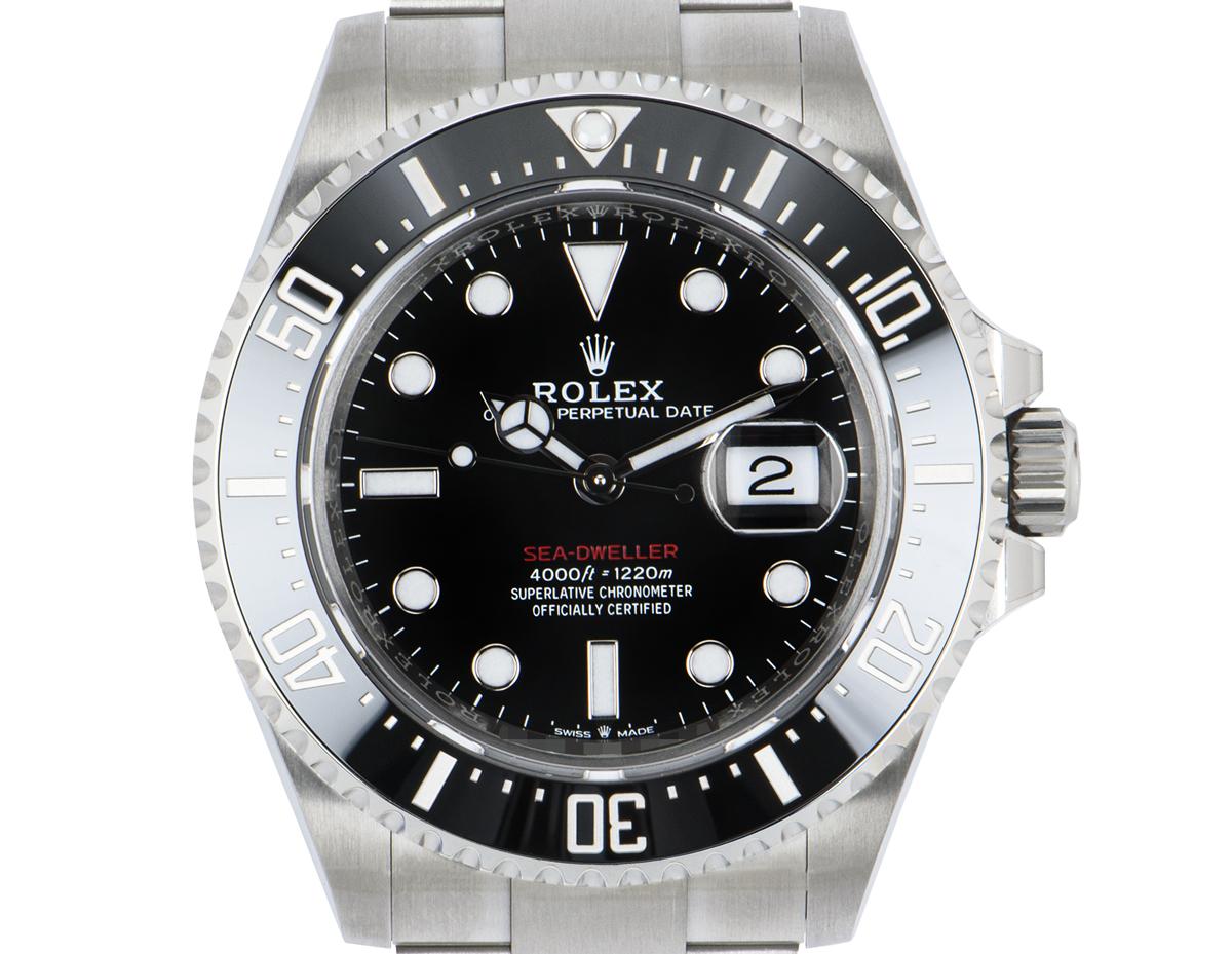 A 43mm, Red Writing Sea-Dweller from Rolex in stainless steel. Featuring a black dial with the date display and covered by a scratch-resistant sapphire crystal. The steel uni-directional rotatable bezel has a ceramic black insert, with 60-minute