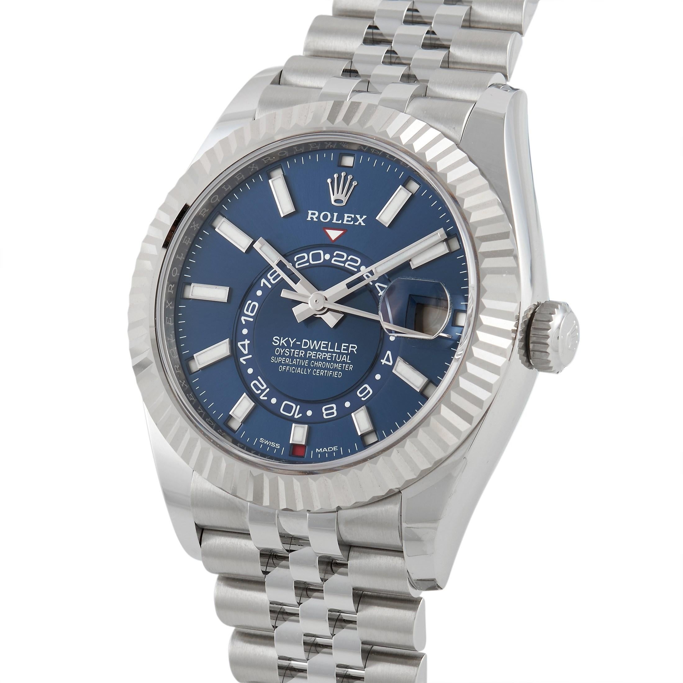 This Rolex Sky-Dweller, reference number 326934, boasts a 42 mm case that is made of stainless steel and fitted with an 18K white gold fluted bezel. The case features Twinlock double waterproofness system and is water-resistant to 100 meters. This