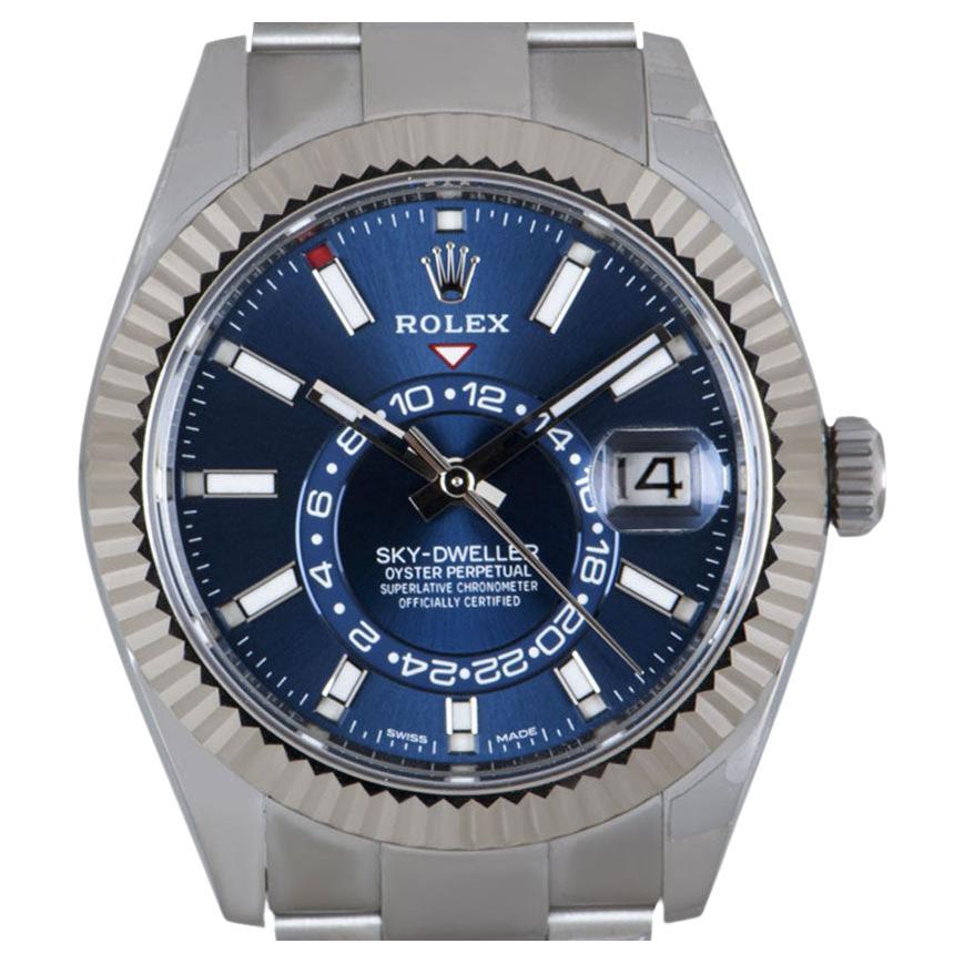 A much sought after stainless steel annual calendar Sky-Dweller by Rolex, with a striking bright blue dial featuring the date, a month display via the 12 apertures, a 24-hour display and second time zone. These can be controlled using the fluted,