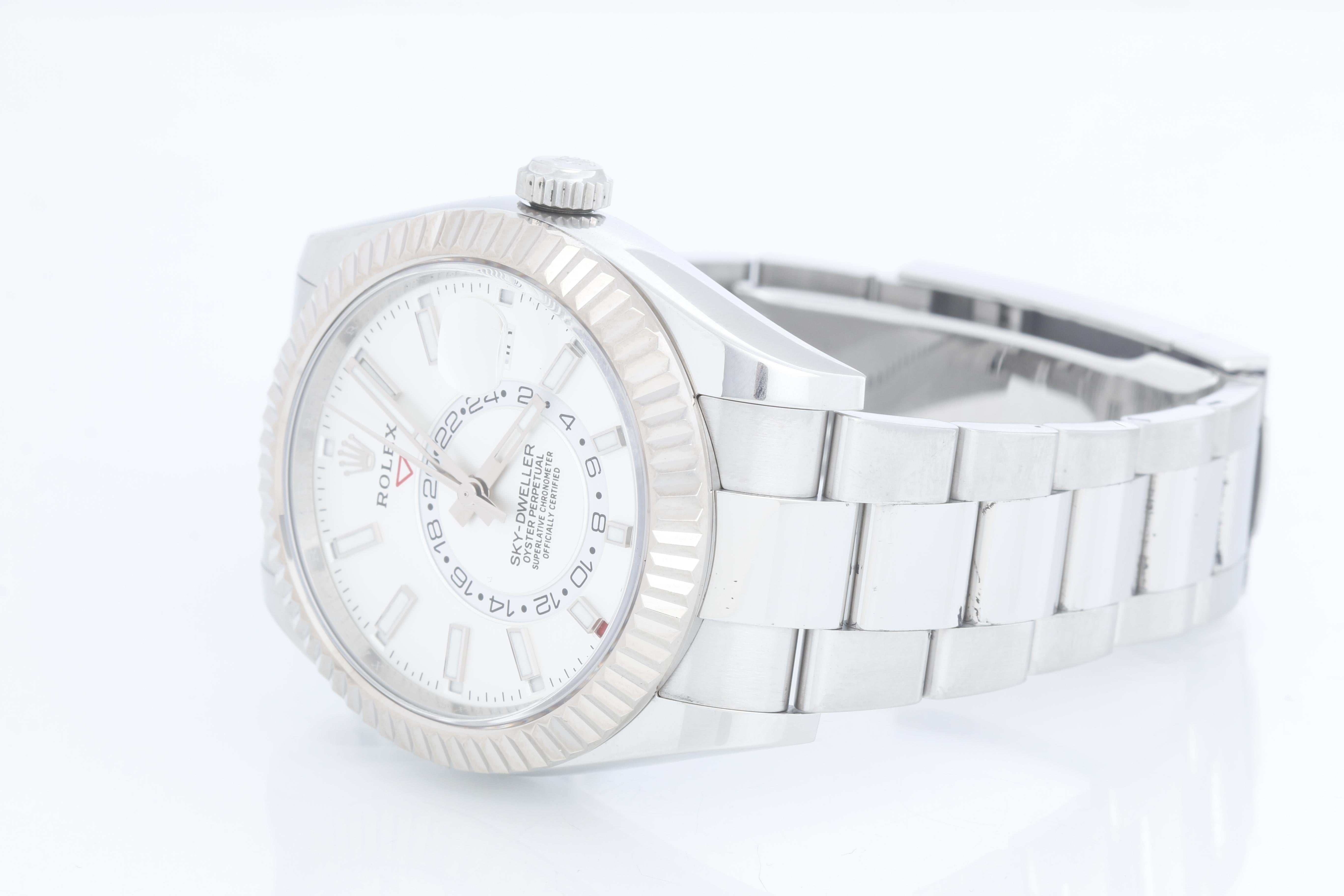 Rolex Sky-Dweller Stainless Steel White Dial 326934 - Automatic, Quickset. Stainless Steel with 18K White gold fluted bezel ( 42 mm ). White dial with index hour markers; date, month, second timezone. Stainless steel with folding clasp. Pre-owned