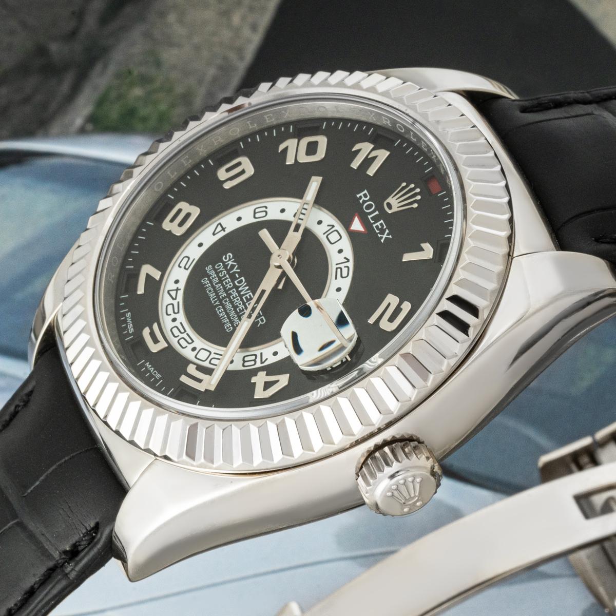 A stainless steel Sky-Dweller by Rolex. Featuring a black dial with a date, a month display via the 12 apertures, and a 24-hour display as well as a second time zone, which can be controlled using the fluted white gold bi-directional rotatable ring