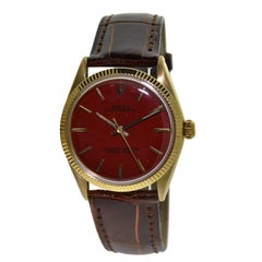 Rolex Yellow Gold Custom Red Dial Oyster Perpetual Wristwatch, circa 1960s