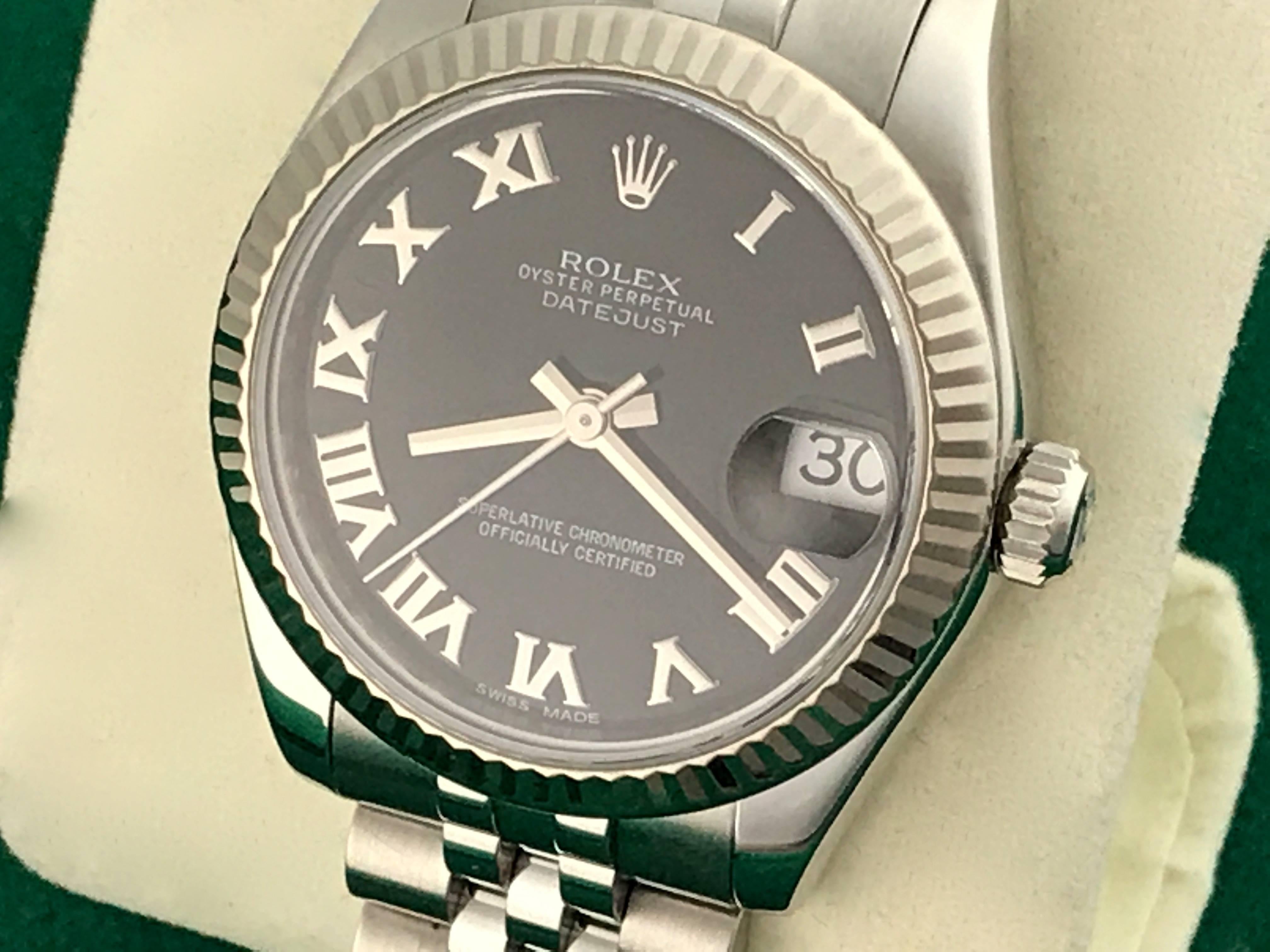 Rolex Datejust Model 178274 Stainless Steel Automatic Midsize Wrist Watch. Certified pre-owned and ready to ship.  Stainless Steel case with 18k white gold fluted bezel, 31mm diameter.  Stainless Steel jubilee bracelet. Black dial with polished