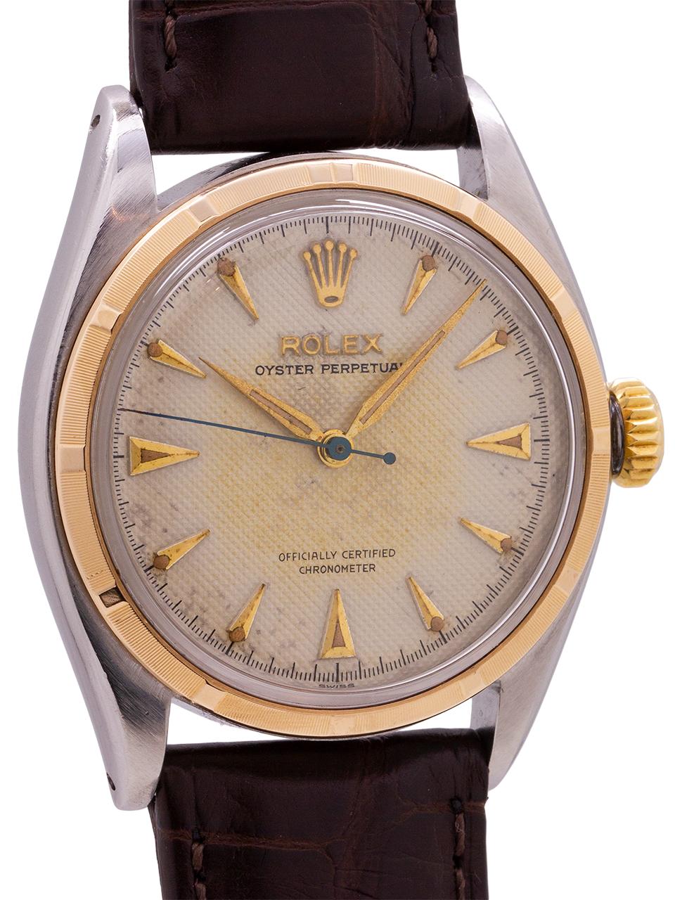 
Rolex Stainless Steel and 14K yellow gold Oyster Perpetual ref 6085, serial #855,xxx circa 1953. Featuring 34mm diameter case with fine engine turned “milled” bezel and acrylic crystal. With an especially pleasing original white honeycomb dial with