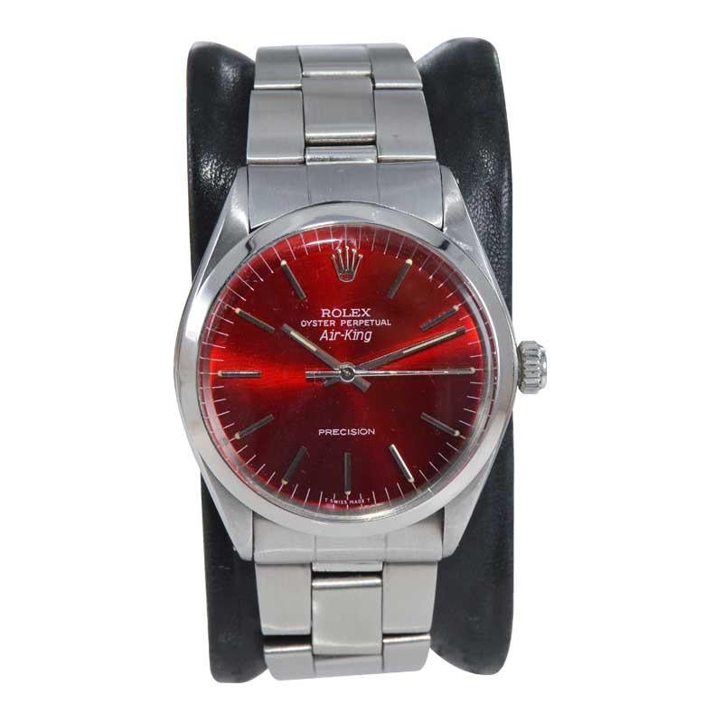 FACTORY / HOUSE: Rolex Watch Company
STYLE / REFERENCE: Air King / Ref. 1002
METAL / MATERIAL: Stainless Steel 
CIRCA: 1970's
DIMENSIONS: 39mm X 35mm
MOVEMENT / CALIBER: Perpetual Winding / 26 Jewels 
DIAL / HANDS: Custom Candy Apple Red Dial /