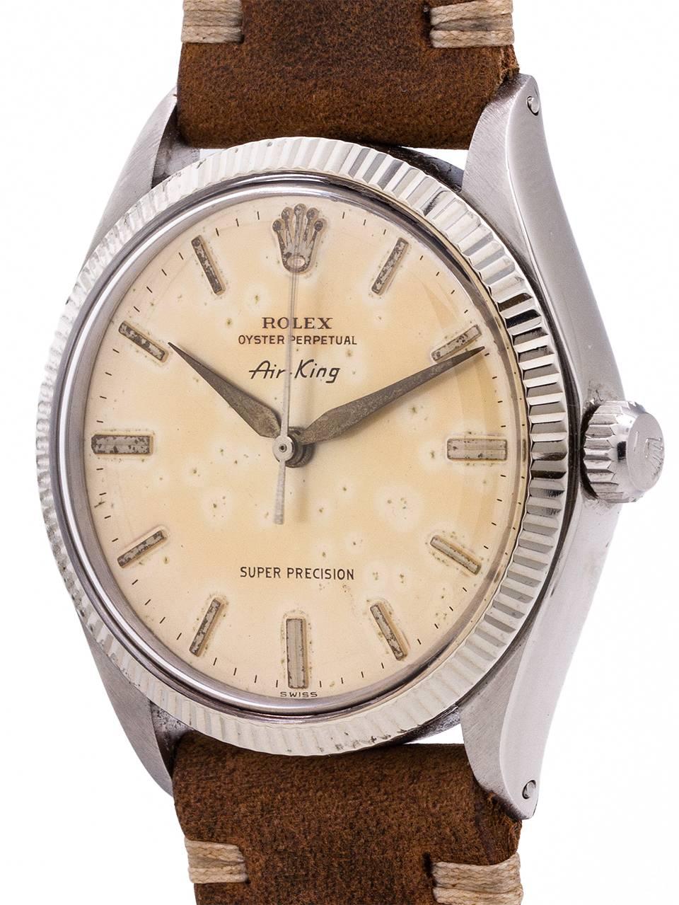 
A terrific looking tropical dial Rolex Airking ref 1005 serial # 3.01 million circa 1971. Featuring a 34mm diameter case with 14K WG fluted bezel with warmly patina’d original silvered dial with raised silver indexes and tapered silver hands. Dial