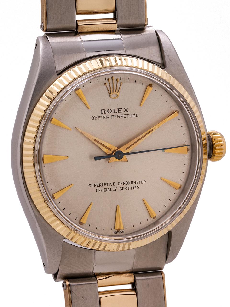 
Rolex Stainless Steel and 14K yellow gold Oyster Perpetual ref 1005 serial #665,xxx circa 1961. Featuring 34mm diameter case with fine engine turned “milled” bezel and acrylic crystal. With original silver satin dial with applied gold indexes and