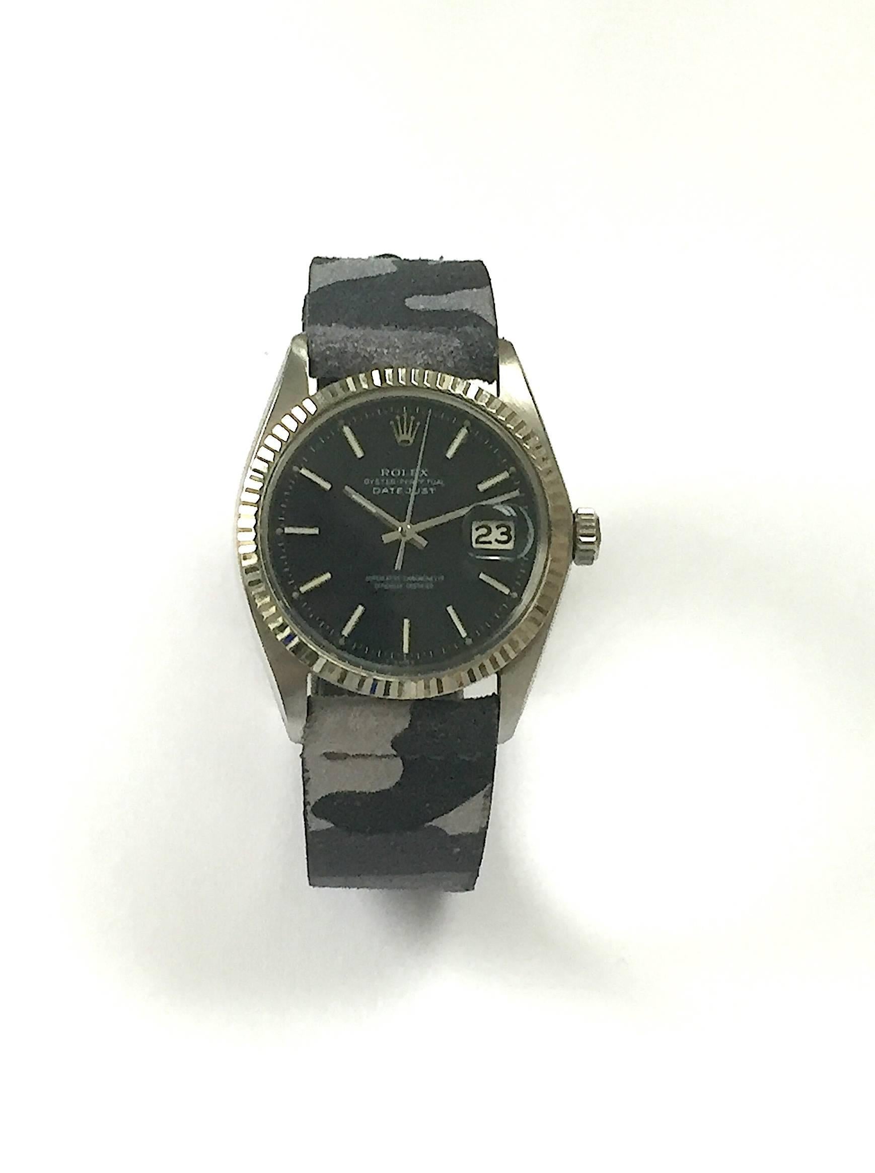 Rolex Stainless Steel and White Gold Oyster Perpetual Datejust Watch
Rare Factory Black Matte Dial with Applied White Hour Markers
White Gold Fluted Bezel
Stainless Steel Case
36mm in size 
Features Rolex Automatic Movement with Calibre 1570 with