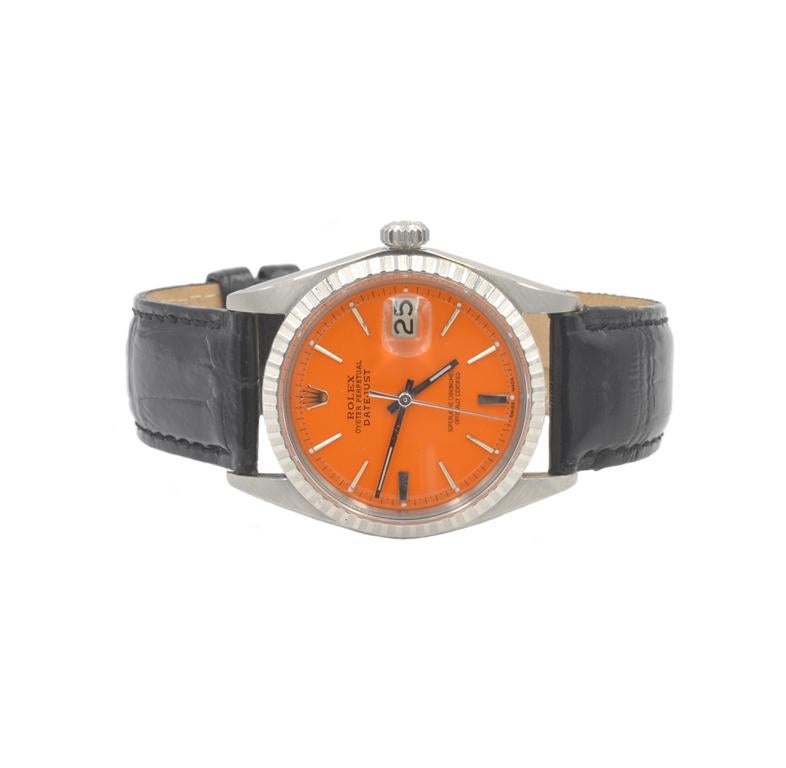 Rolex Datejust 36mm 1964 1747xxx, reference 1603.  Custom orange dial and new black leather strap.  Automatic movement.

This watch includes a one year warranty from the time of purchase for accurate timekeeping.
