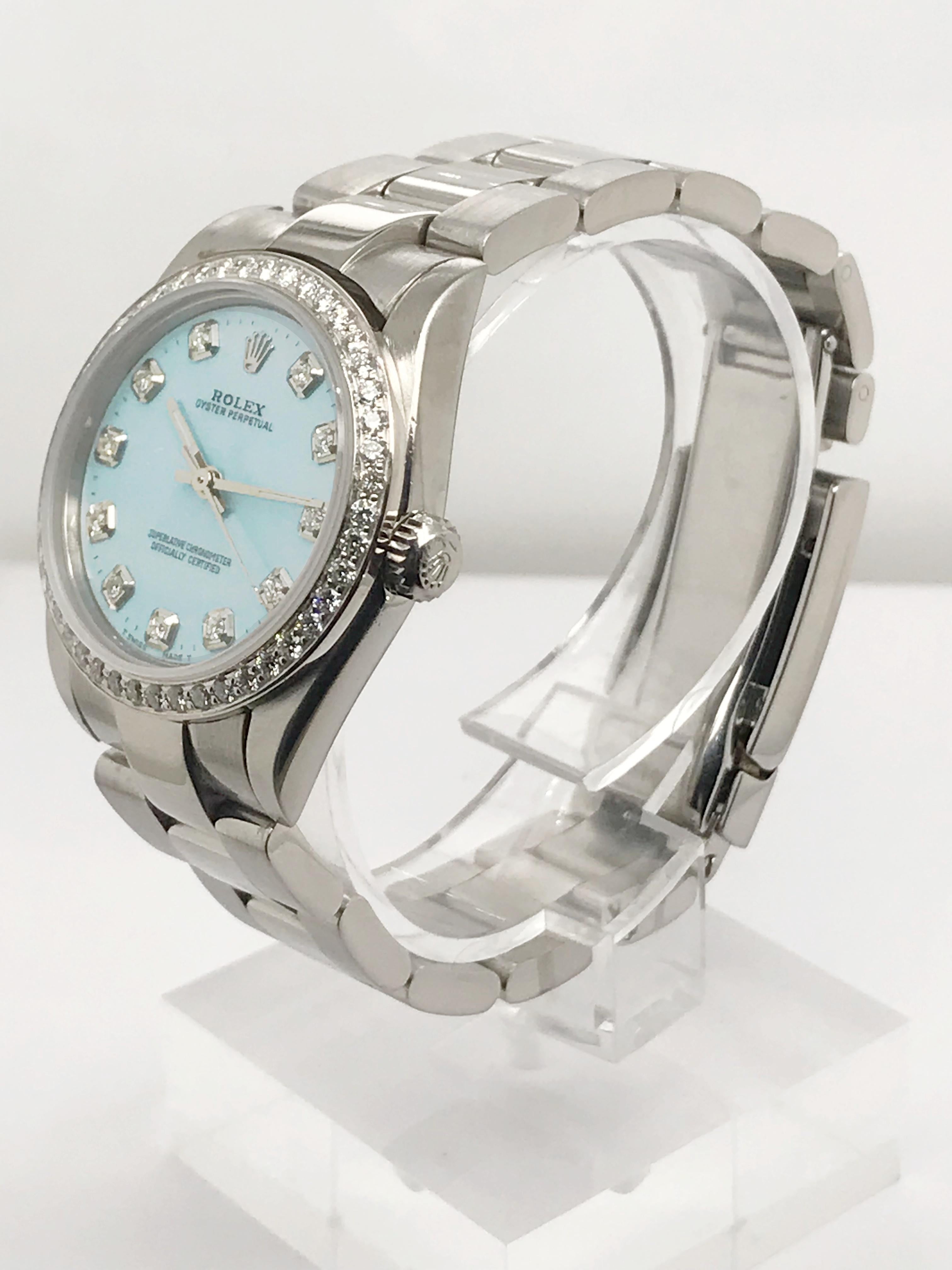 This Stainless Steel 31mm Midsize Rolex offers a beautiful pop if Icy blue color with its dial that also features sparkling diamond markers. Oyster link bracelet in stainless steel with flip lock clasp. Also featuring a diamond bezel this watch is
