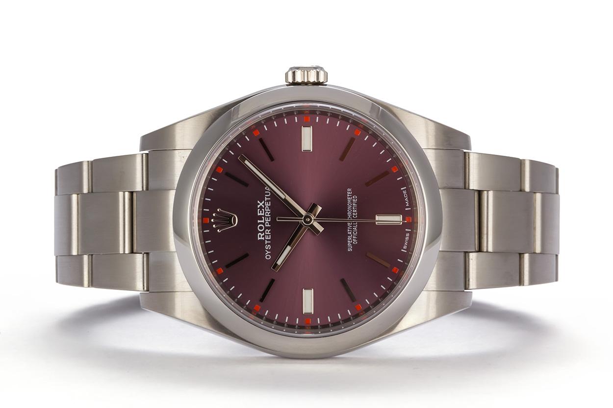 We are pleased to offer this Rolex Stainless Steel Oyster Perpetual 39 114300. This newer larger version of the classic Rolex Oyster Perpetual features a 39mm stainless steel case, factory original stainless steel smooth bezel, red grape dial,