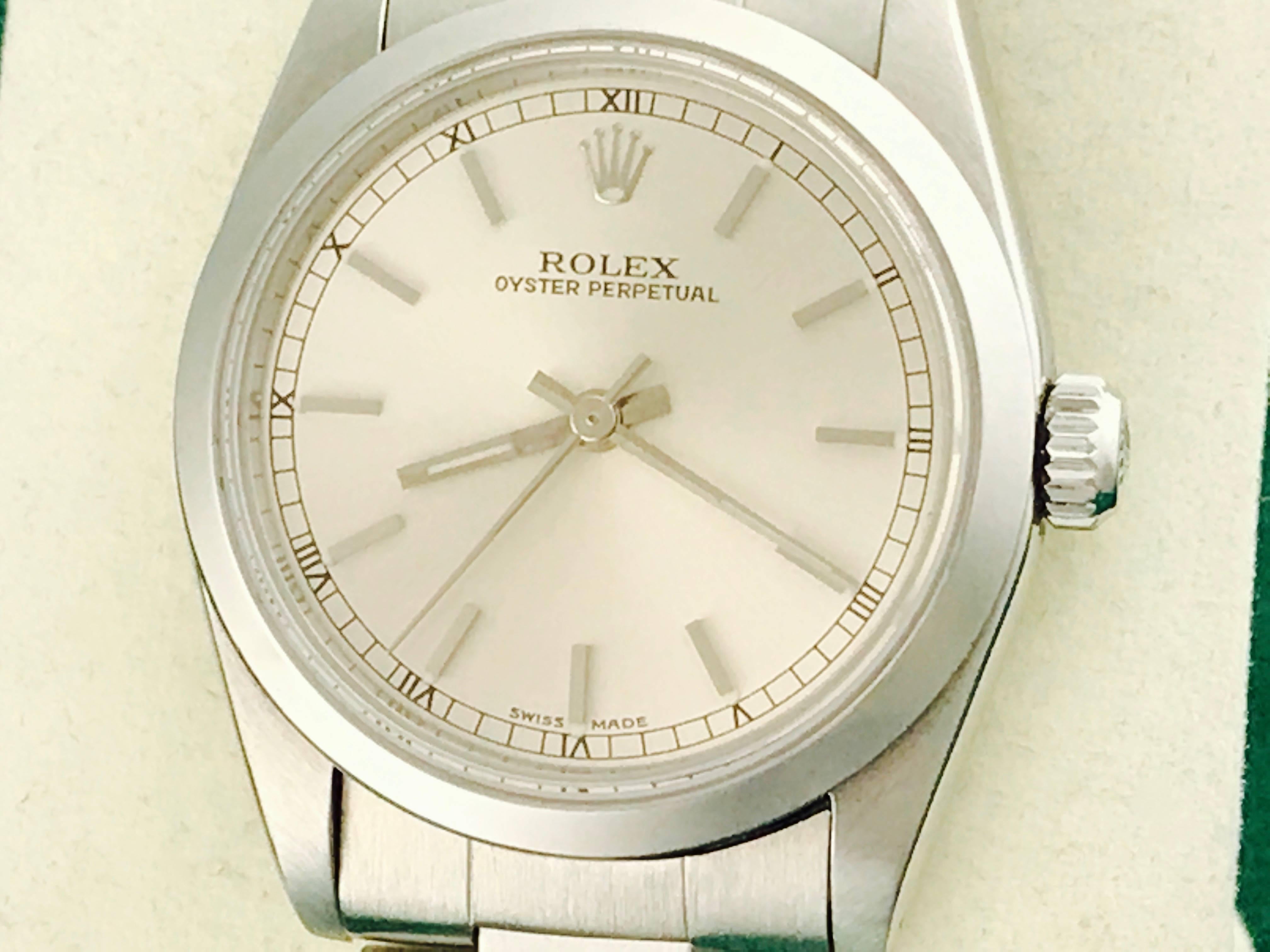 Mens Rolex Oyster Perpetual Model 77080 Stainless Steel Automatic Wrist Watch. Certified pre-owned and ready to ship.  Stainless Steel case with smooth bezel, 30mm diameter.  Stainless Steel oyster bracelet. Silver dial with polished hour markers. 