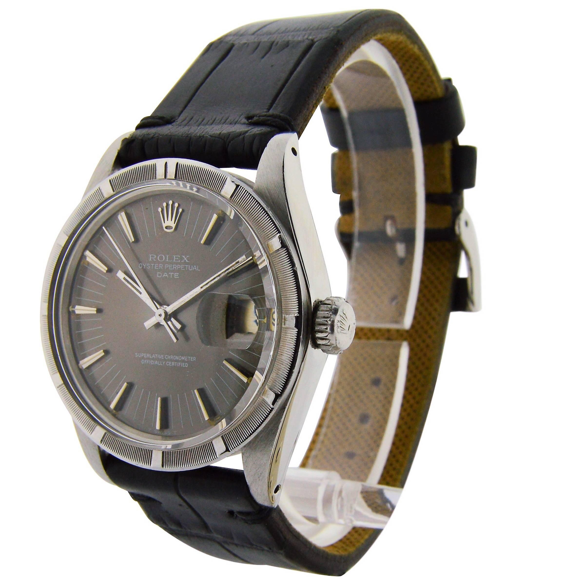 FACTORY / HOUSE: Rolex Watch Company
STYLE / REFERENCE: Oyster Perpetual Date / Thunderbird Bezel
CIRCA: 1972
MOVEMENT / CALIBER: 26 jewel / Caliber 1570
DIAL / HANDS: Original, Charcoal / Baton Indices / Baton Hands
DIMENSIONS:   38mm X 