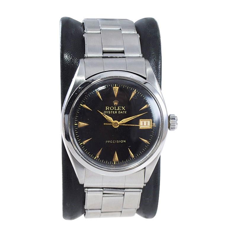 FACTORY / HOUSE: Rolex Watch Co.
STYLE / REFERENCE: Oyster Date / Reference 6294
METAL / MATERIAL: Stainless Steel
CIRCA / YEAR: 1953
DIMENSIONS / SIZE: 40mm x 34mm
MOVEMENT / CALIBER: Manual Winding / 17 Jewels 
DIAL / HANDS: Original Black / Gold