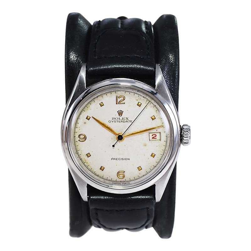 FACTORY / HOUSE: Rolex Watch Company
STYLE / REFERENCE: Oyster Date / Reference 6094
METAL / MATERIAL: Stainless Steel 
CIRCA / YEAR: 1956
DIMENSIONS / SIZE: Length 39mm X Diameter 34mm
MOVEMENT / CALIBER: Manual Winding / 17 Jewels 
DIAL / HANDS: