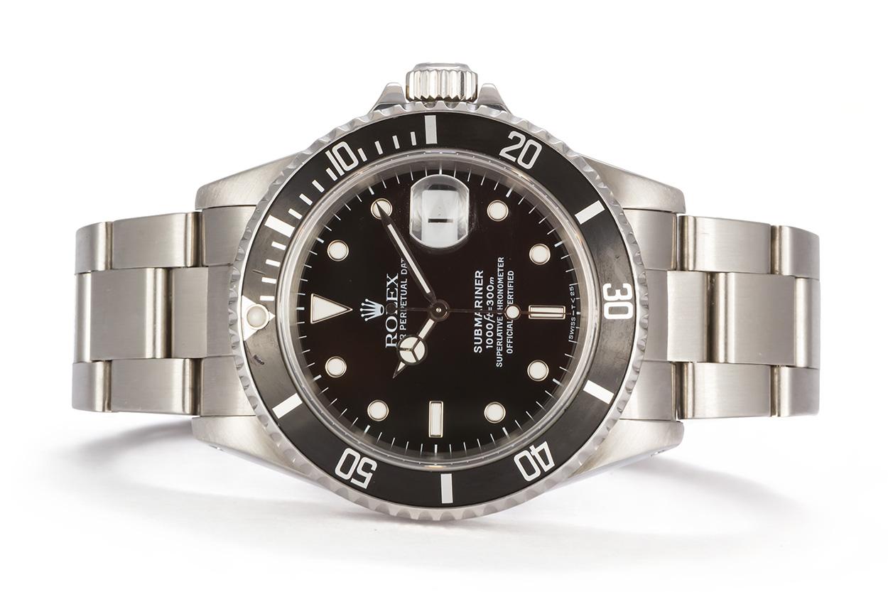 We are pleased to offer this 1997 Rolex Stainless Steel Submariner 16610. This classic and highly sought after Rolex sport watch features a 40mm stainless steel case, factory original black metal insert time-lapse bezel and factory original black