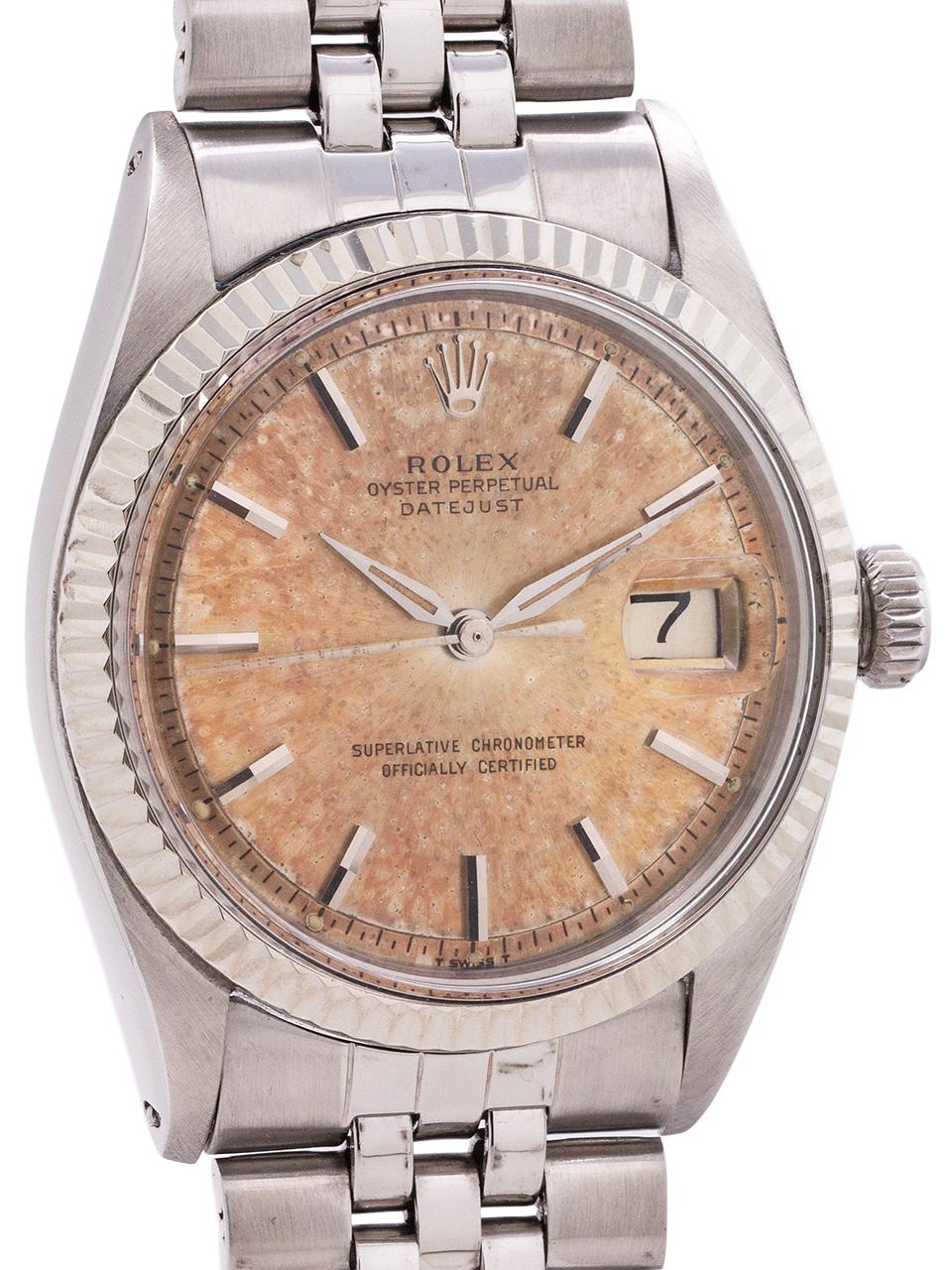 Rolex Stainless Steel Datejust ref 1601 serial # 8.9 million circa 1962. Full size man’s 36mm diameter case with 14K white gold fluted bezel and acrylic crystal with a richly patina’d “Tropical Peach” colored dial. With stick indexes and with early