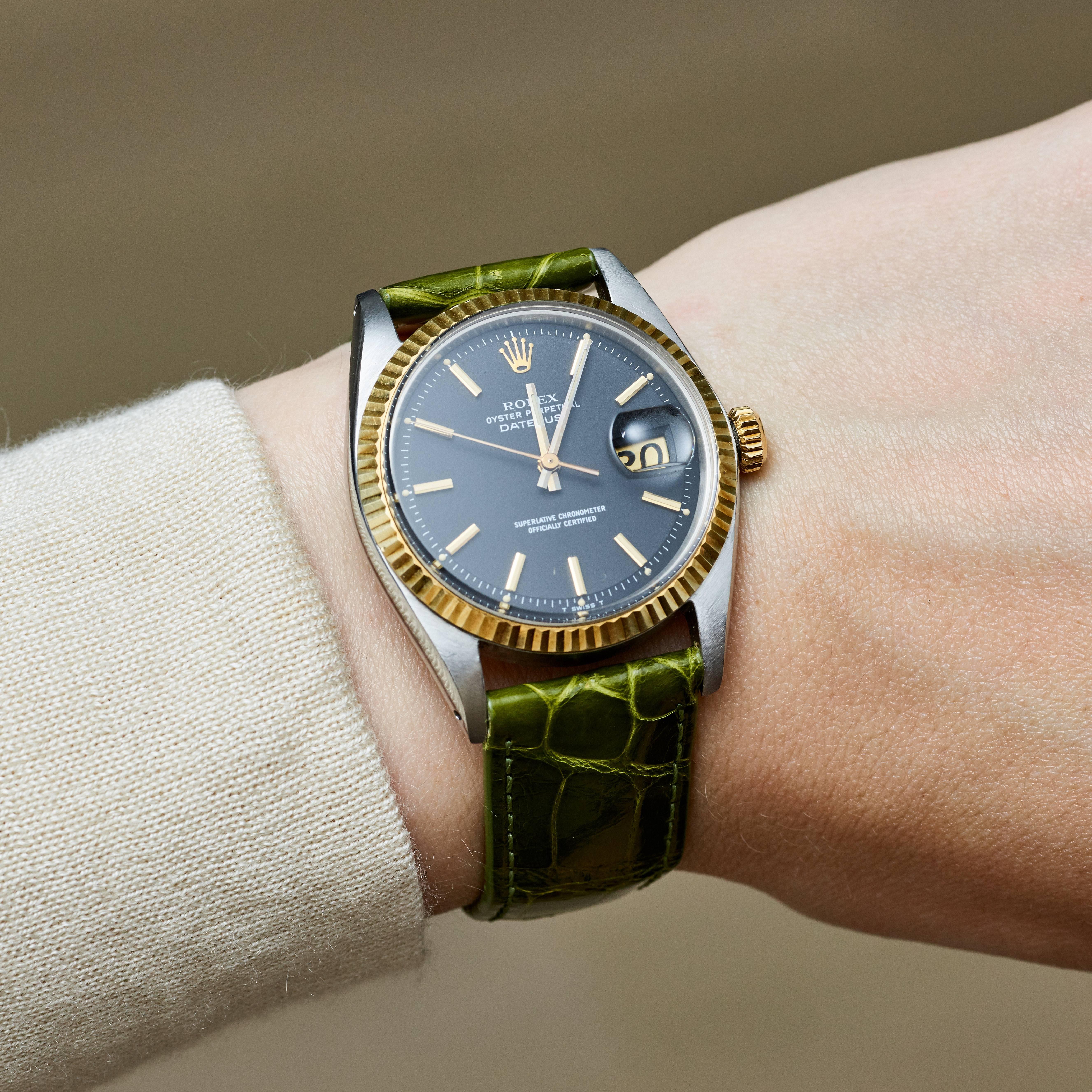 Rolex Stainless Steel and Yellow Gold Oyster Perpetual Datejust Watch with Papers
Rare Factory  Charcoal Colored T Swiss T Dial with Applied Hour Markers
Yellow Gold Fluted Bezel
Stainless Steel Case
36mm in size 
Features Rolex Automatic Movement