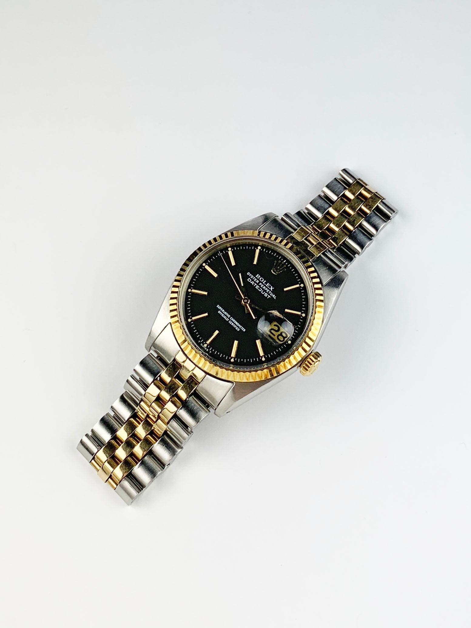 Rolex Stainless Steel and Yellow Gold Oyster Perpetual Datejust Watch with Papers
Rare Factory  Charcoal Colored T Swiss T Dial with Applied Hour Markers
Yellow Gold Fluted Bezel
Stainless Steel Case
36mm in size 
Features Rolex Automatic Movement