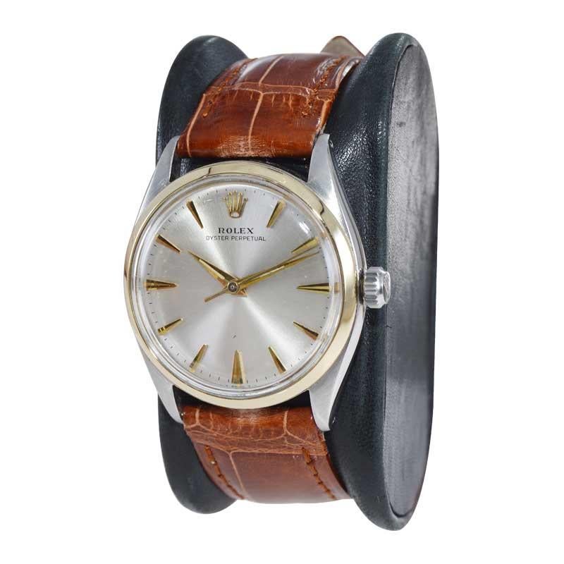 FACTORY / HOUSE: Rolex Watch Company
STYLE / REFERENCE: Oyster Perpetual / Reference 6564
METAL / MATERIAL: Stainless Steel / 14Kt. Gold Bezel
CIRCA / YEAR: Mid 1950's
DIMENSIONS / SIZE: Length 39mm x Diameter 34mm
MOVEMENT / CALIBER: Perpetual