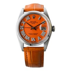 Rolex Oyster Perpetual Date in acciaio con quadrante arancione personalizzato e indici di diamante anni
70 Rolex Oyster Perpetual Date in acciaio con quadrante arancione personalizzato e indici di diamante anni
70