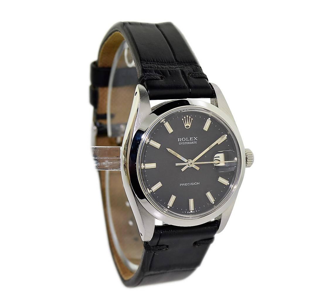 FACTORY / HOUSE: Rolex Watch Company
STYLE / REFERENCE: Oysterdate / 6694
METAL / MATERIAL: Stainless Steel
DIMENSIONS:  39mm  X  34mm
CIRCA: 1969 / 1970
MOVEMENT / CALIBER: Manual Winding / 17 Jewels 
DIAL / HANDS: Original Black w/ Baton Markers /