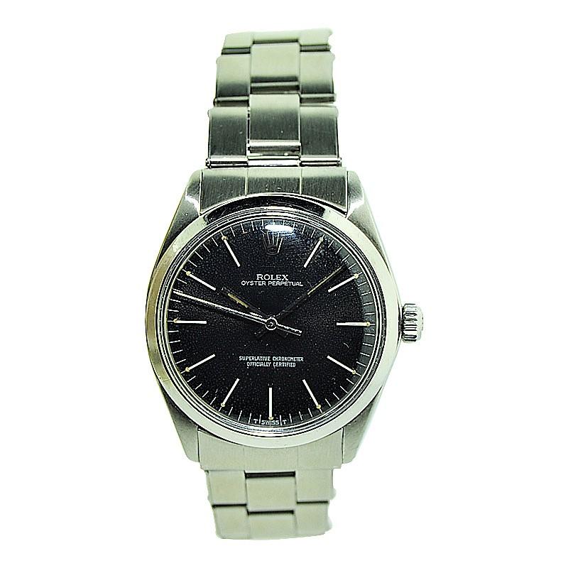 FACTORY / HOUSE: Rolex Watch Co.
STYLE / REFERENCE: Oyster Perpetual / Ref 1005
METAL / MATERIAL: Steel
CIRCA / YEAR: Mid 1960's
DIMENSIONS / SIZE: 39mm X 34mm
MOVEMENT / CALIBER: Perpetual Winding / 26 Jewels 
DIAL / HANDS: Original Black Dial /