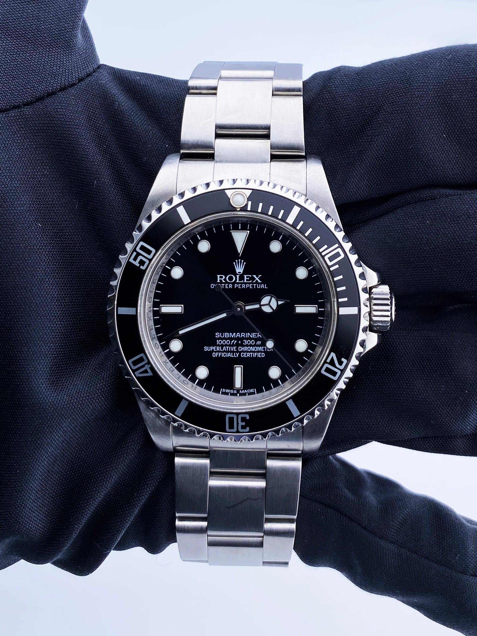 
Rolex Oyster Perpetual Submariner 14060M Mens Watch. 40mm stainless steel case with unidirectional stainless steel bezel with black bezel insert. Black Dial with luminous Mercedes hands and luminous index hour markers. Minute markers on the