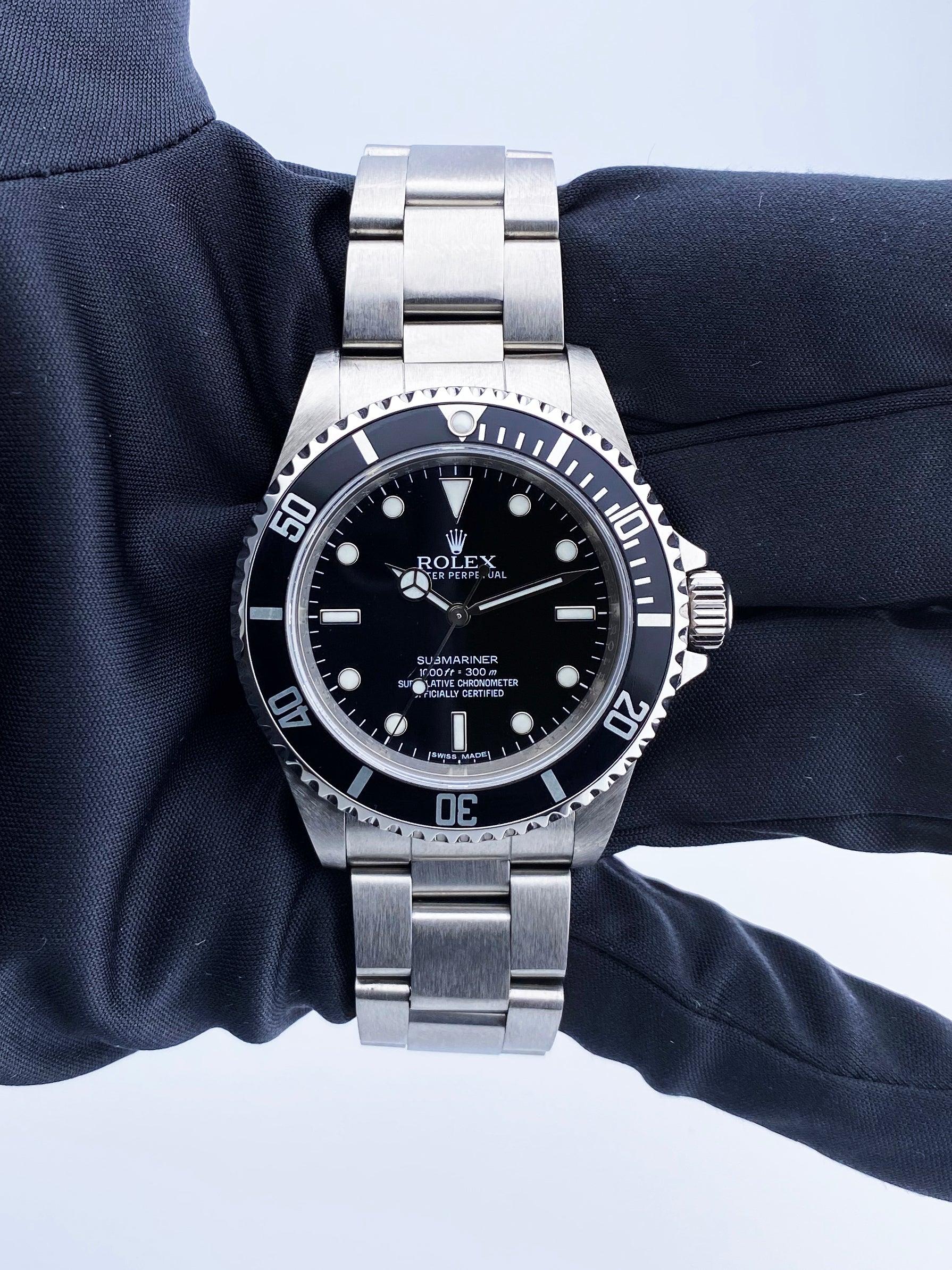Rolex Oyster Perpetual Submariner 14060M Mens Watch. 40mm stainless steel case with unidirectional stainless steel bezel with black bezel insert. Black Dial with luminous Mercedes hands and luminous index hour markers. Minute markers on the