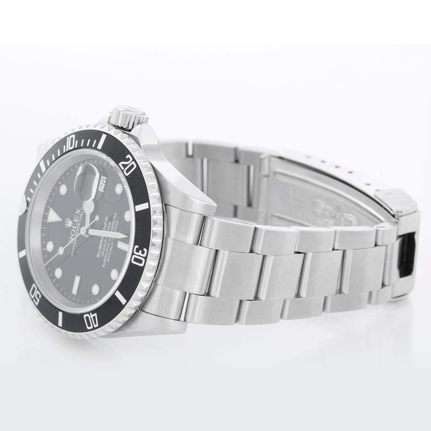 Rolex Submariner 16610 Stainless Steel Men's Watch - Automatic winding, 31 jewels, Quickset, sapphire crystal. Stainless steel case; rotating bezel with black insert. Black Dial. Stainless steel Oyster band . Pre-owned with custom box with paper