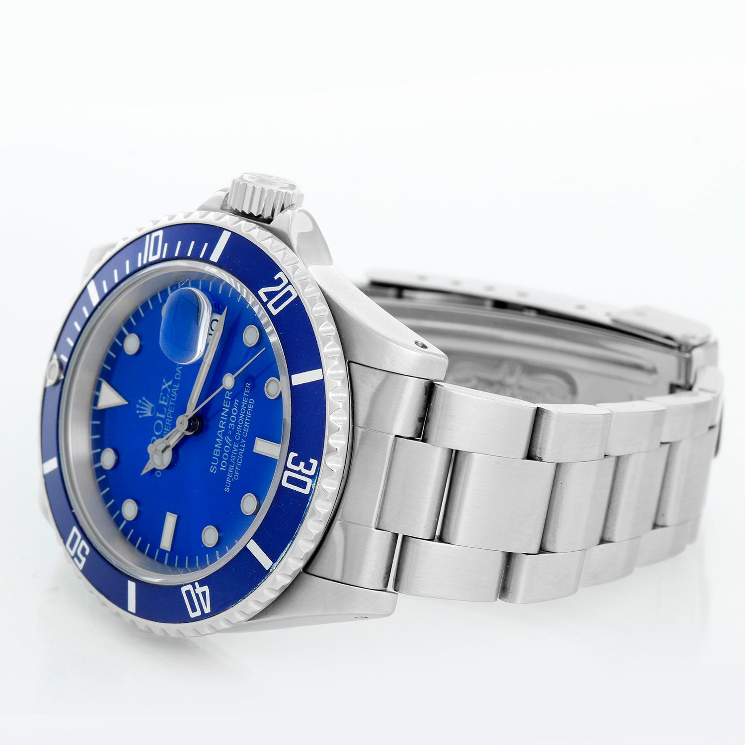 Rolex Submariner 16610 Stainless Steel Men's Watch - Automatic winding, 31 jewels, Quickset, sapphire crystal. Stainless steel case; rotating bezel with blue insert. Custom Blue dial with luminous hour markers. Stainless steel Oyster bracelet with