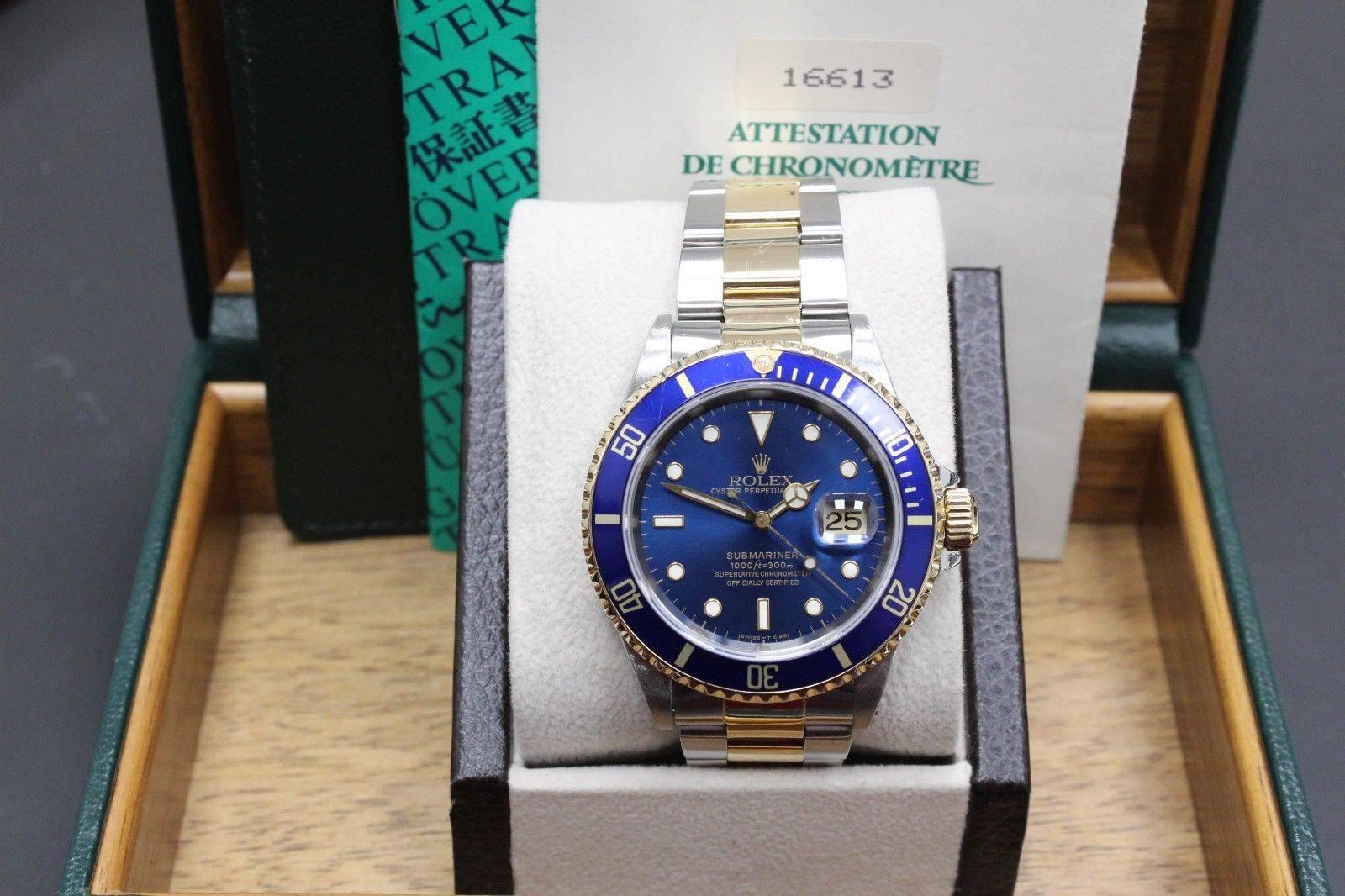 Style Number: 16613
Serial: W896***
Model: Submariner
Case: Stainless Steel 
Band: 18K Yellow Gold & Stainless Steel
Bezel: Blue
Dial: Blue
Face: Sapphire Crystal 
Case Size: 40mm 
Movement: Automatic
Includes: 
-Original Rolex Box &