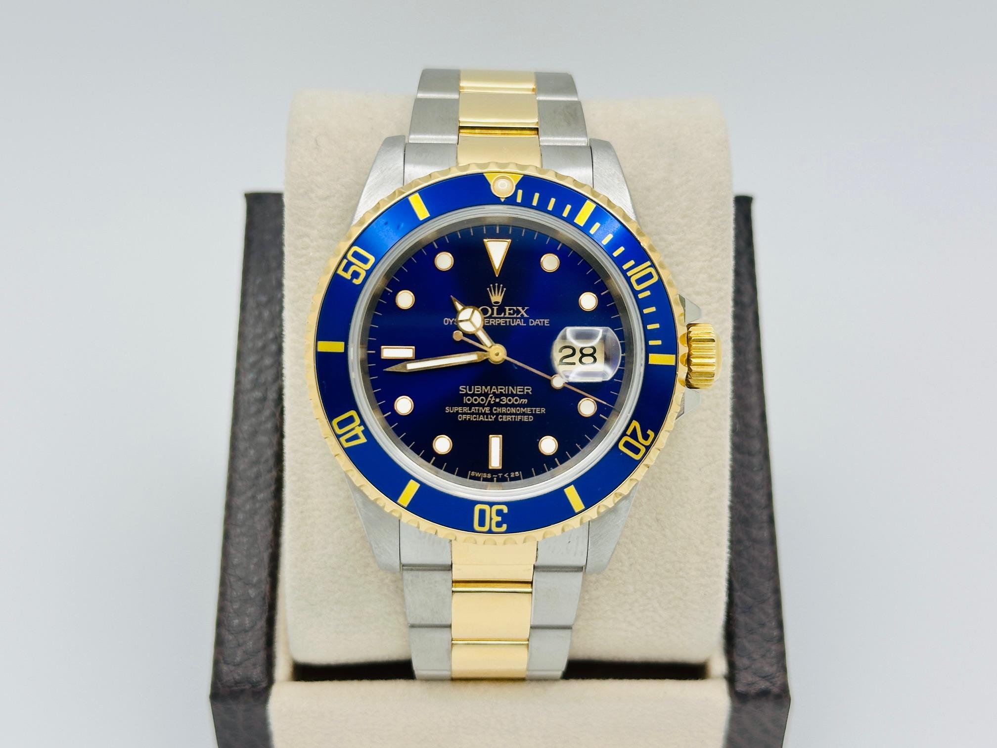 Style Number: 16613

Serial: S319***

Year: 1993

Model: Rolex Submariner

Case Material: Stainless Steel

Band: 18K Yellow Gold & Stainless Steel

Bezel: Blue

Dial: Blue

Crystal: Sapphire Crystal

Case Size: 40mm

Includes: 
-Elegant Watch Box