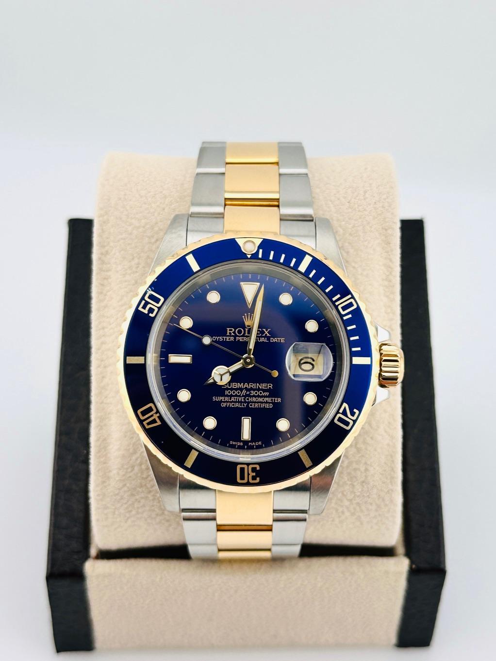 Style Number: 16613

Serial: P711***

Year: 2000

Model: Rolex Submariner

Case Material: Stainless Steel

Band: 18K Yellow Gold & Stainless Steel

Bezel: Blue

Dial: Blue

Face: Sapphire Crystal

Case Size: 40mm

Includes: 
-Elegant Watch