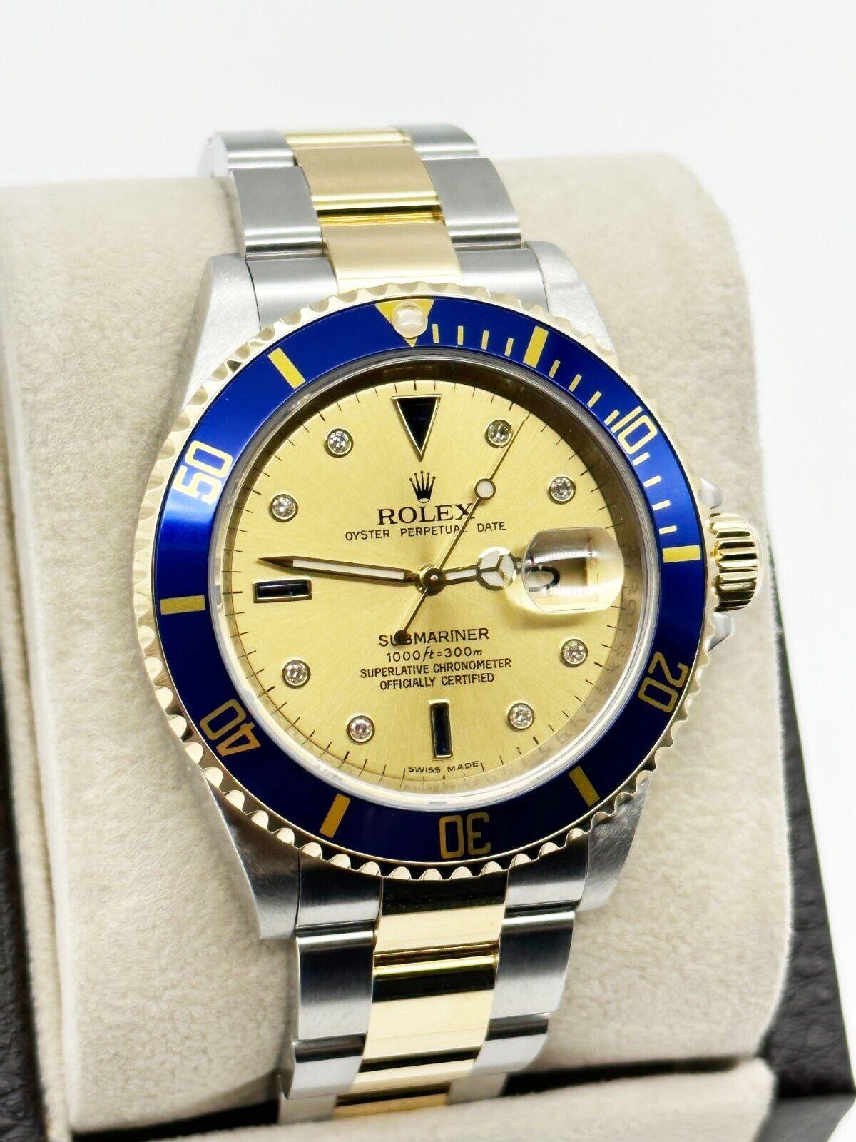 Style Number: 16613
 
Serial: Z990***

Year: 2006
 
Model: Submariner
 
Case Material: Stainless Steel 
 
Band: 18K Yellow Gold & Stainless Steel 
 
Bezel: 18K Yellow Gold
 
Dial: Original Champagne Serti Dial with Diamonds and Sapphires 
 
Face: