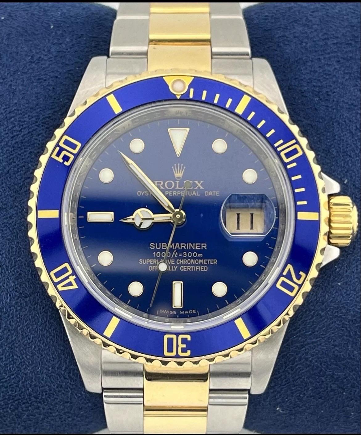 The Rolex Submariner 16613 REHAUT Two-Tone 18K Steel Date 40mm Blue No-Holes Watch is a striking blend of sport and luxury, designed for those who appreciate both performance and elegance. The 40mm case combines the durability of stainless steel