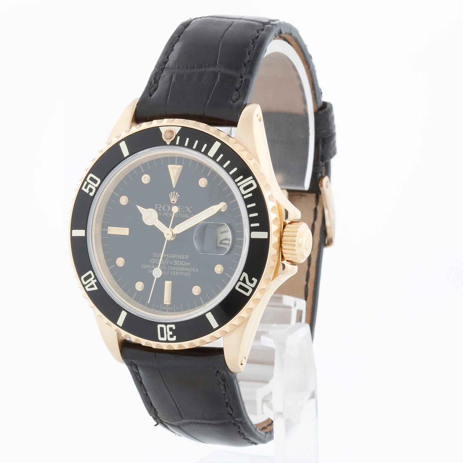 Rolex Submariner 16808 Automatic Mens Watch - Automatic. 18K Yellow gold case with black insert ( 40 mm ). Black dial. Rolex black leather strap with Rolex tang buckle. Pre-owned with custom box.