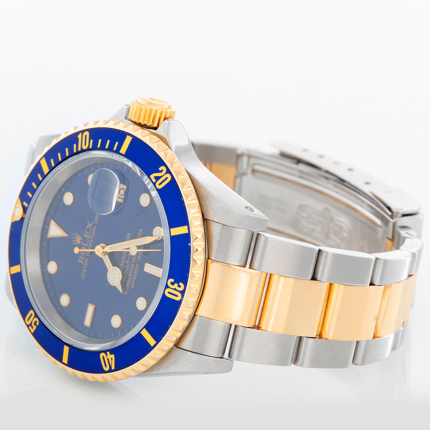 Rolex Submariner 2-Tone Steel & Gold Men's Watch 16613 - Automatic winding. Stainless steel case with gold rotating bezel with blue insert. Blue dial. Rolex oyster bracelet. Pre-owned with Rolex box and papers