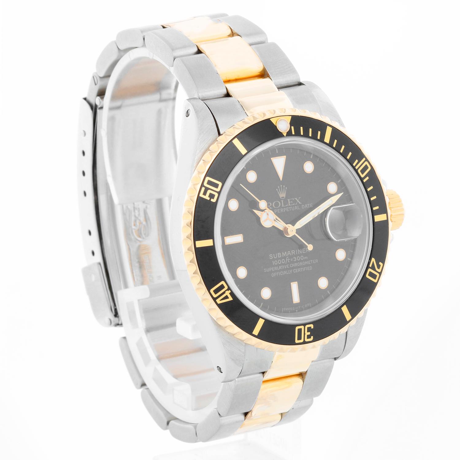 Rolex Submariner 2-Tone Steel & Gold Men's Watch 16613 - Automatic winding, 31 jewels. Stainless steel case with 18k yellow gold bezel with black insert (40mm diameter). Black dial with hour markers; date at 3 o'clock. Stainless steel and 18k yellow